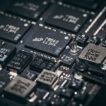 Close de microchips e componentes eletrônicos em uma placa de circuito.
