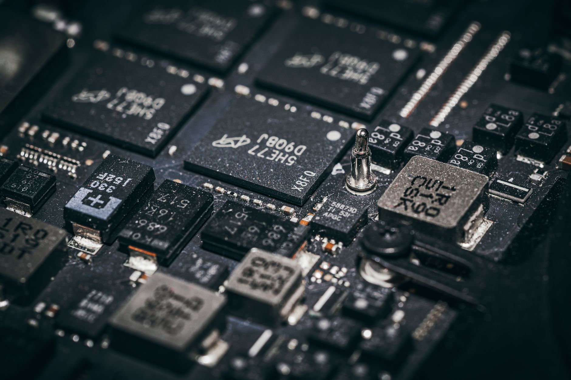 Close de microchips e componentes eletrônicos em uma placa de circuito.